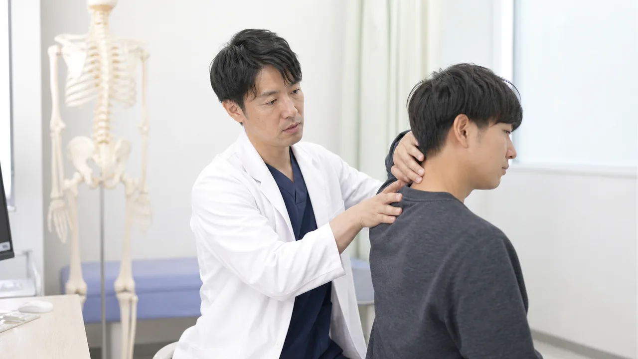 交通事故後の首と肩を整形外科医が診察する場面